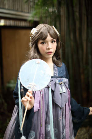 Portrait of asian girl in chinese lolita fashion dress in garden background