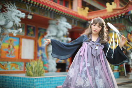 Portrait of a girl with Chinese lolita dress costume with chinese gardenのeditorial素材