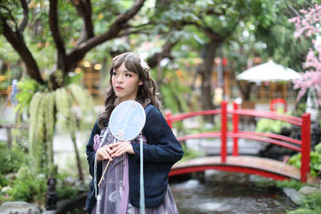 Portrait of asian girl in chinese lolita fashion dress in garden backgroundのeditorial素材