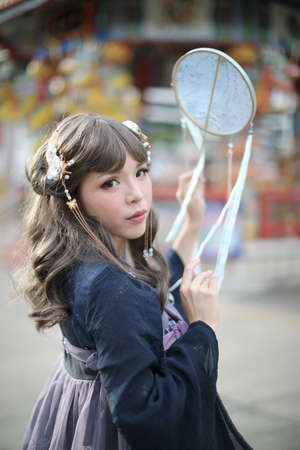 Portrait of a girl with Chinese lolita dress costume with chinese gardenのeditorial素材