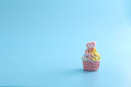 Colorful cupcake isolated in blue backgroundの写真素材