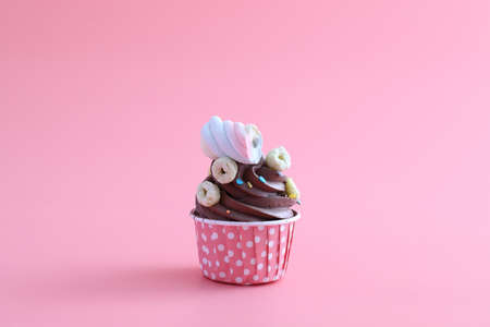 Chocolate cupcake isolated in pink backgroundの写真素材