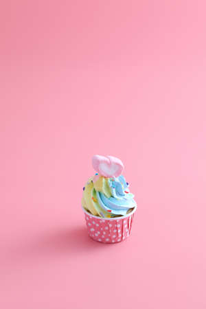 colorful cupcake isolated in pink backgroundの写真素材