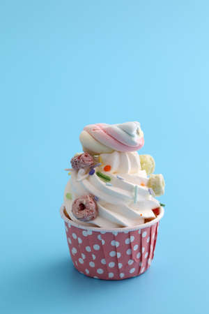 Colorful cupcake isolated in blue background