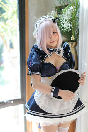 portrait of girl with japanese maid costume in vintage restaurantの写真素材