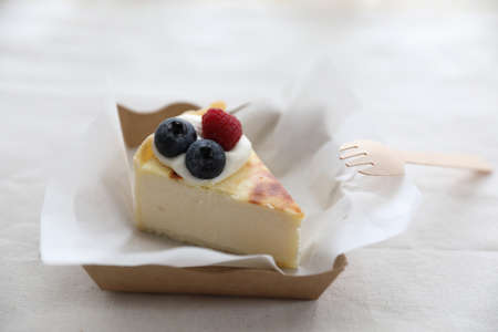 Cheesecake with berry in takeout box