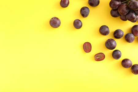 Red grapes isolated top view in yellow backgroundの写真素材