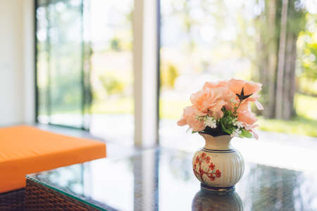 pink flower in jar on wood table with space for textの写真素材