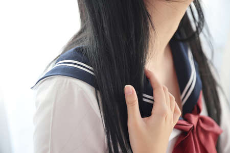 Close up of Asian High School Girl shoulder in white roomの写真素材