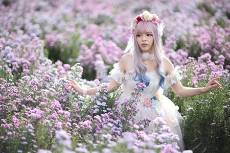 Beautiful young woman with white lolita dress with flowers garden Japanese fashionの写真素材