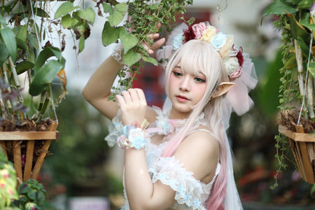 Beautiful young woman with white lolita dress with flowers garden Japanese fashionの写真素材