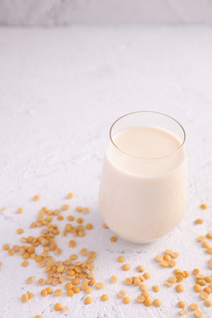 Soy milk in glass and soy bean isolated in white backgroundの写真素材