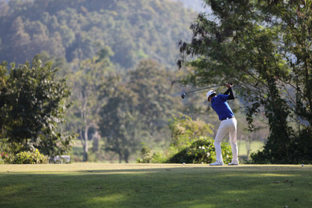 Young male golfer player on golf courseの写真素材