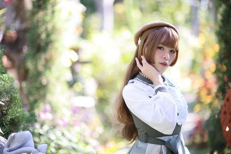 A beautiful woman in lolita dress in garden background Japanese street fashion portrait
