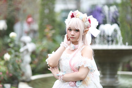 Beautiful young woman with white lolita dress with flowers garden Japanese fashionの写真素材