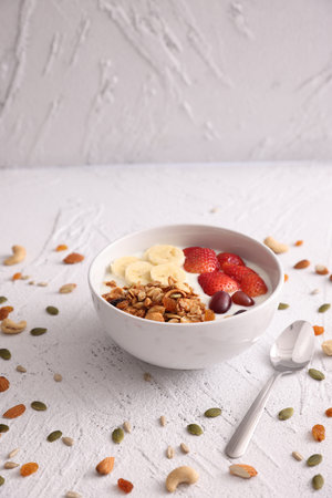 bowl of granola cereal with yogurt and berries isolated on white backgroundの写真素材