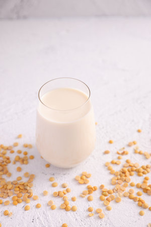 Soy milk in glass and soy bean isolated in white backgroundの写真素材