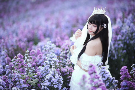 Beautiful young woman with white lolita dress with european garden Japanese fashionの写真素材
