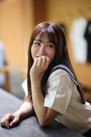 Japanese high school student relax in coffeeshopの写真素材