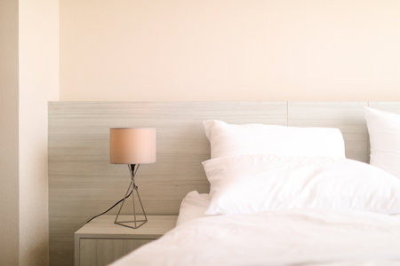 bed in a modern white tone loft roomの写真素材