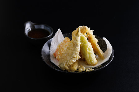 Mix tempura with shrimp fish and vegetable Japanese food isolated in black backgroundの写真素材