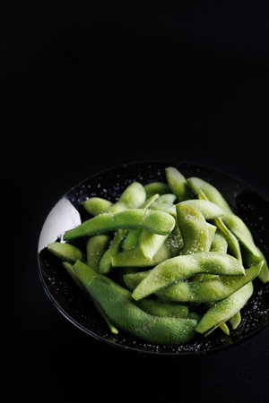 Edamame green soybeans isolated in black backgroundの写真素材