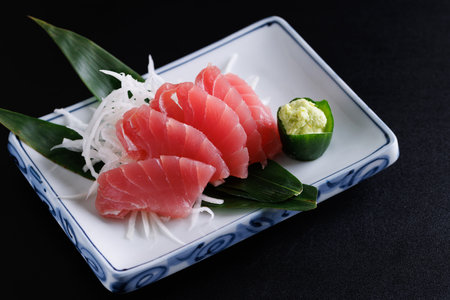 Tuna sashimi isolated in black backgroundの写真素材