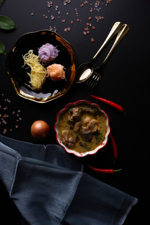 Chicken green curry with Rice Noodle Traditional northern local Thai food isolated in black...