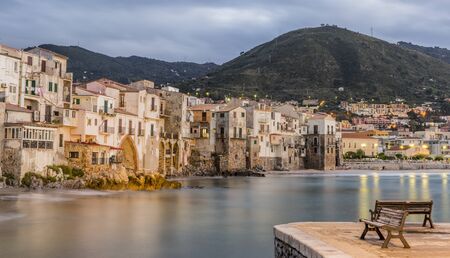 Beautiful harbor view of old houses in Cefalu at dusk, Sicilyの写真素材