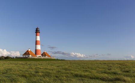 Colorful lighthouse at Westerhever, Germanyの写真素材