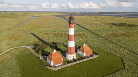 Colorful lighthouse at Westerhever, Germanyの写真素材