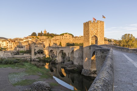 The Medieval Bridge in the ancient town of Besalu at sunriseの写真素材