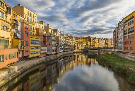 Colorful houses on the banks of the Onyar river in Gironaのeditorial素材