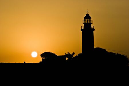Silhouette of Paphos lighthouse at sunset, Cyprusの写真素材