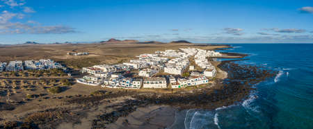 Aerial view of Caleta de Famara village in the El Jable desert, Lanzarote, Spainの写真素材