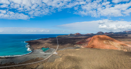 Charco Verde lake, volcan Bermeja and black sand beach on the island of Lanzarote, Spainの写真素材