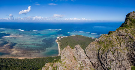 Aerial view of Le Morne Mountain summit in Mauritius with peninsula and oceanの写真素材