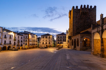 Morning view of Plaza Mayor with Torre de Bujaco in historic Caceres, Spain