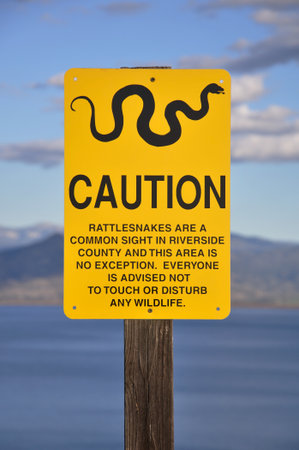 Warning sign along a hiking trail at Diamond Valley Lake in Hemet, California.の写真素材