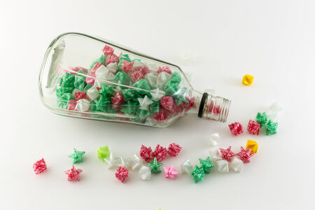 Paper stars in  whisky bottle on white backgroundの写真素材