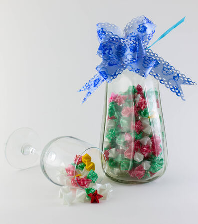Paper stars in  whisky bottle and glass on white backgroundの写真素材