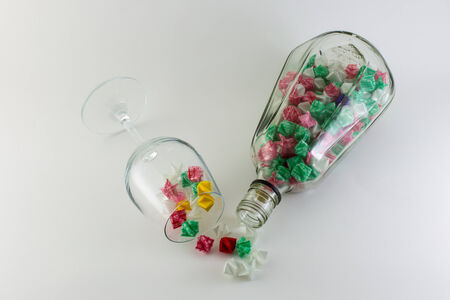 Paper stars in  whisky bottle and glass on white backgroundの写真素材