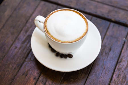 Hot coffee cup on wooden tableの写真素材