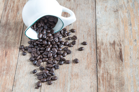 Coffee beans on  wooden backgroundの写真素材