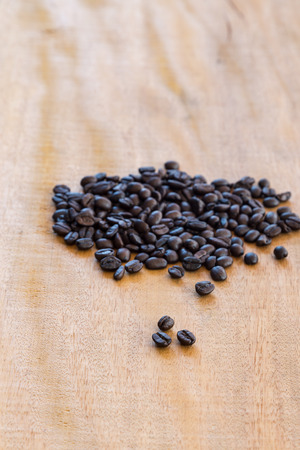 Coffee beans on wooden backgroundの写真素材