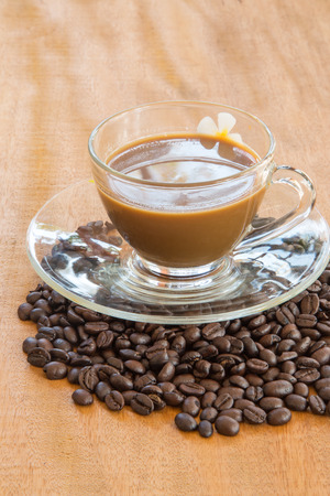 Coffee and coffee beans on wooden backgroundの写真素材