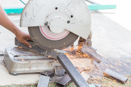 cutting steel rod by machine on a day at the construction siteの写真素材