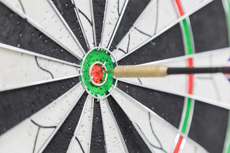 Dart board with dart on bullseyeの写真素材
