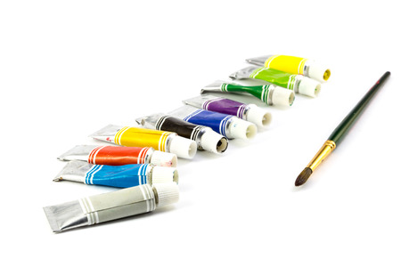 Tubes of  colored paint and brush on white backgroundの写真素材
