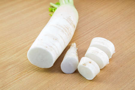 Daikon radishes  on woodden backgroundの写真素材